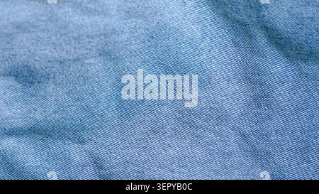 Blue crumpled jeans denim fabric texture close up. Stock Photo