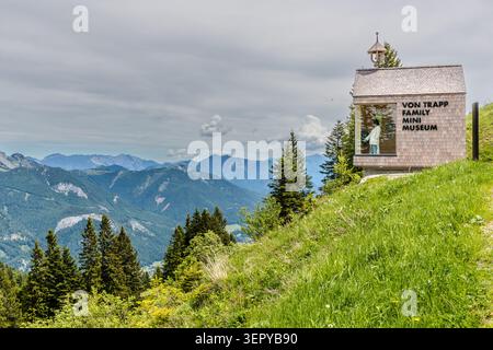 The ‘Von Trapp Family Mini Museum’ on a mountain meadow on the Zwölferhorn (1,522 m) near Sankt Gilgen, overlooking the Salzburg mountains; the wooden-shingled pavilion, which opened at Whitsun 2026, documents the history of the von Trapp family and their connection to the region. Sankt Gilgen, Salzkammergut, Salzburg, Austria Stock Photo