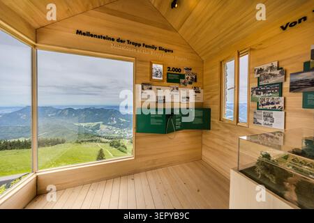 Interior view of the Von Trapp Pavilion on the Zwölferhorn (1,522 m) above St Gilgen on Lake Wolfgang: Opened at Whitsun in 2026, the wooden pavilion houses the exhibition ‘Milestones of the Trapp Family Singers’, featuring historical photographs and documents. Through the panoramic window, visitors can see the Salzkammergut region and the village of St. Gilgen. St. Gilgen, Salzburg, Austria Stock Photo