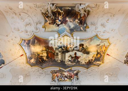 A Baroque ceiling painting in a state room of the Archbishop’s Residence (DomQuartier Salzburg): the multi-part fresco, set in a gilded stucco frame featuring putti, depicts allegorical scenes. The Residence on Residenzplatz served as the main residence of the Archbishops of Salzburg from 1587 to 1812. Salzburg, Austria Stock Photo