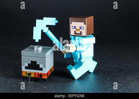 Lego Minecraft Character, trying to work on a crafting table. Stock Photo