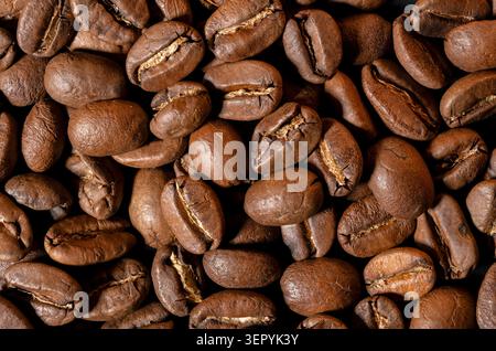 Macro close-up photography of roasted brown coffee beans creating a seamless background texture Stock Photo