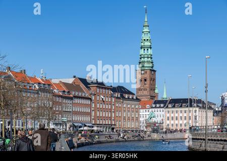 Copenhagen, Denmark-April 11, 2026; Neo-Baroque spire of former St. Nicholas Church now Nikolaj Kunsthal contemporary arts center with in forefront Ga Stock Photo