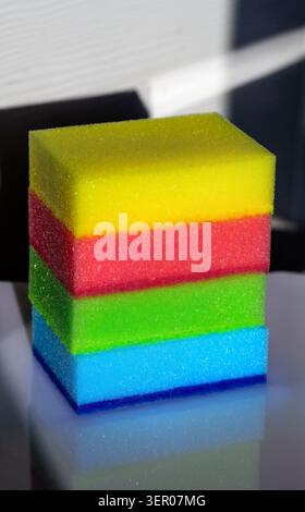 Colorful household cleaning sponges and scouring pads arranged on a clean background, representing hygiene, dishwashing and domestic chores Stock Photo