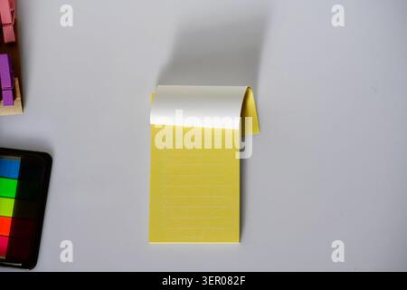 Small paper notepad with blank or lined pages on a clean background, a practical stationery item for notes, lists, planning and office organization Stock Photo