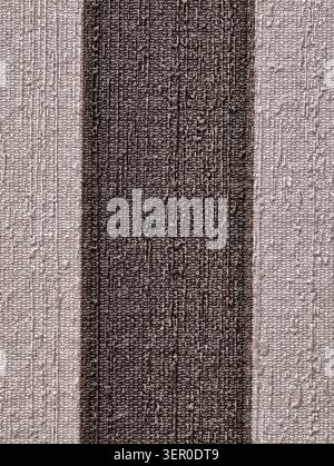 Textured woven textile shown in close-up with a prominent dark vertical stripe running down the center. The fabric displays tight horizontal and verti Stock Photo