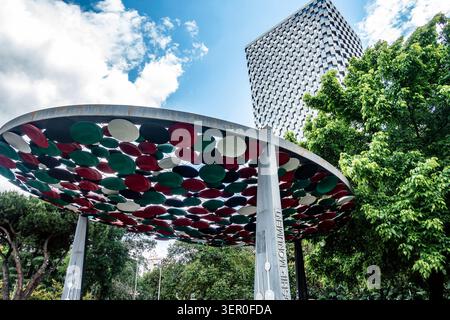 The canopy structure of the Friendship Monument with the modern Plaza hotel skyscraper in the background under a blue sky in Tirana, Albania. Stock Photo