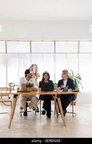 Business people collaborating during office meeting, discussing strategies Stock Photo
