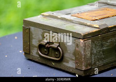 Vintage wooden storage chest with metal hardware and aged weathered surface. A close-up view shows an old rectangular wooden box Stock Photo