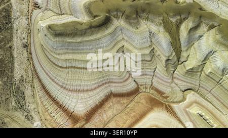 Aerial view of the vibrant multi-colored sedimentary rock layers and unique geological formations of the Kyzylkup tract, Aktau, Mangystau Region, Kaza Stock Photo