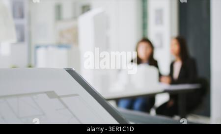 Specialists at creative agency gather data on plans and determine real scale dimensions to guarantee that the building crew gets correct items, architects researching 3D printed structures Stock Photo