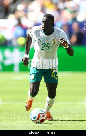 El Hadji Malick Diouf of Senegal is challenged by Jules Kounde of ...