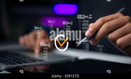 hand holding stylus pen pointing at virtual checklist boxes and correct tick mark icon on laptop. Concept of quality control, business compliance, sur Stock Photo
