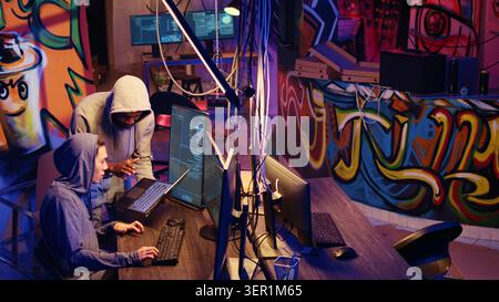 Hacker group coordinating DDoS attack on website, sending large amounts of traffic from multiple sources to overwhelm it, rogue programmers working together to flood target server, slowing it down. Stock Photo