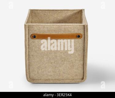 Stylish beige felt storage box with leather handle, ideal for organizing belongings Stock Photo