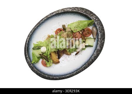 Salad with fried potato lettuce pickled cucumbers and tomatoes on decorate plate isolated on white background Stock Photo