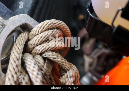 Rope knot metal closeup texture equipment safety outdoor strong durable create detailed view of tightly knotted rope looped through metal ring highlig Stock Photo