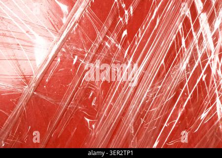 Transparent plastic wrap texture abstract red background shiny crumpled surface create abstract background with shiny crumpled plastic wrap texture ov Stock Photo