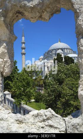 The view of Suleymaniye Mosque through the stone wall frame. The Suleymaniye Mosque is an Ottoman imperial mosque of Istanbul, Turkey Stock Photo