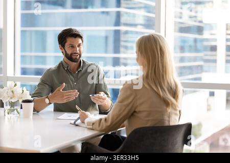 Two business colleagues discussing ideas during meeting Stock Photo