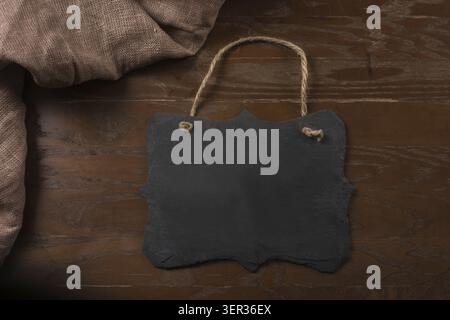 Rectangular black textured slate board for dishes on brown table Stock Photo