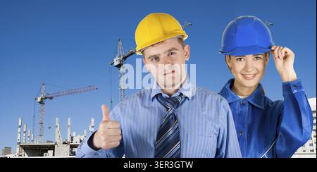 Portrait of architects at in front of construction site, building and crane Stock Photo