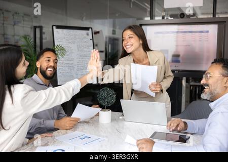 Two happy team members giving high five during training Stock Photo