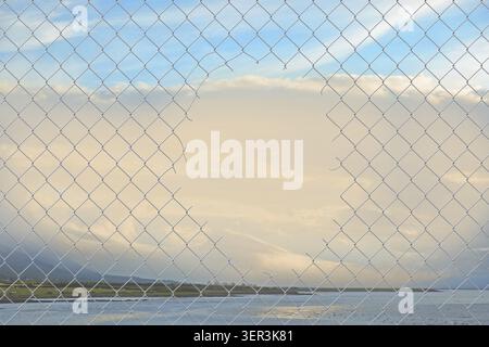 Hole in a chain link fence Stock Photo