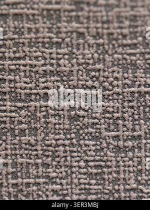 Macro view of a gray woven carpet showing looped pile and tufted texture, revealing interlaced loops and flat backing fibers under soft directional li Stock Photo