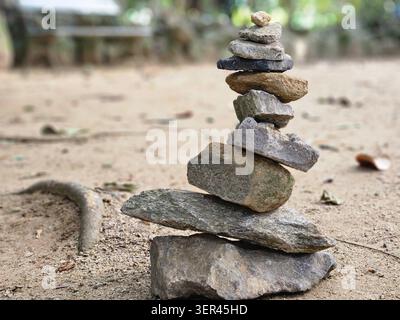 Balanced stone cairn in the Japanese garden, Jardim Botânico botanical garden, Rio de Janeiro, Brazil Stock Photo