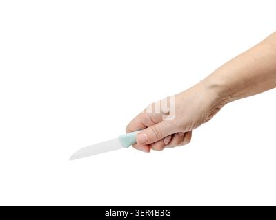 Woman's hand holding a ceramic kitchen knife on the white isolated background. Stock Photo