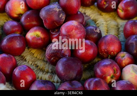 Ripe Red Nectarines in a Rustic Basket Stock Photo