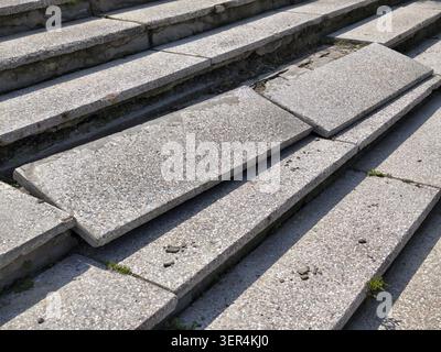 Photo of a stone granite staircase with broken steps Stock Photo
