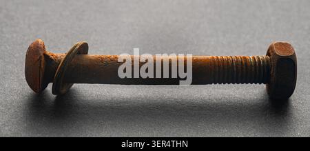 rusty construction bolt on a black background Stock Photo