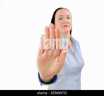 Middle aged brunette woman standing over white background doing stop with palm of the hand. warning expression with negative and serious gesture on th Stock Photo
