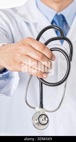 Cropped shot of an unrecognizable male doctor offering out an stethoscope at hospital Stock Photo