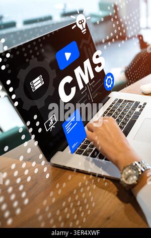 Working on a content management system with a laptop and digital elements in a modern office Stock Photo
