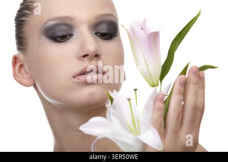 Portrait of beautiful dark haired slavonic model posing with flower Stock Photo