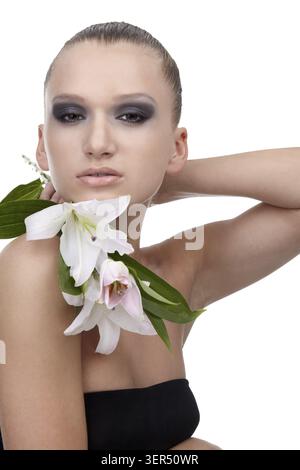 Portrait of beautiful dark haired slavonic model posing with flower Stock Photo