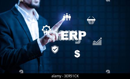 Business person interacts with ERP software using a touch screen in an office setting Stock Photo