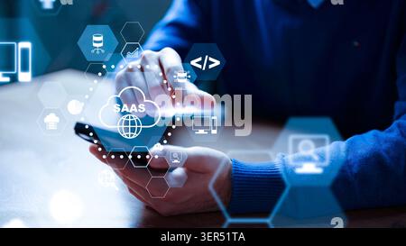Person using smartphone to explore SaaS technology and solutions in office setting Stock Photo