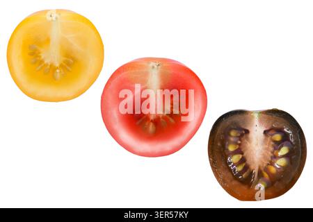Cut yellow red and black cherry tomatoes isolated on white background Stock Photo