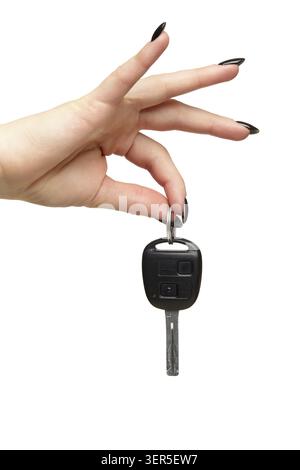 A female hand with a black nails manicure holds a black car key with her fingers. Car sharing concept. Isolated on white background Stock Photo