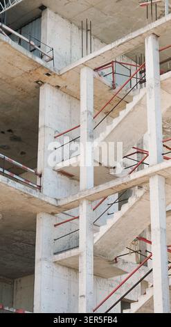 Concrete stairs and pillars at a highrise building construction site closeup. Stock Photo