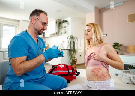 Doctor preparing medication for a woman suffering from a painful skin allergy Stock Photo