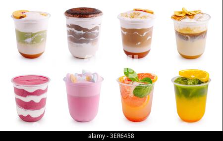 Assorted cold coffee beverages and fruit smoothies are presented on white background. Large set of takeaway layered drinks includes fruit slices and toppings. Stock Photo