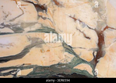 Marble surface with green and brown veining in indoor setting during daylight. Stock Photo