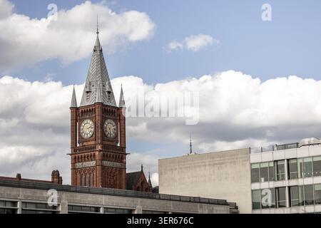 View of the historic red brick Victoria Building clock tower at the University of Liverpool under a cloudy blue sky in Liverpool, England, United King Stock Photo