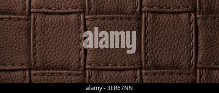 Texture dark brown leather background with quilted stitched pattern, macro. Abstract chocolate upholstery surface. Stock Photo