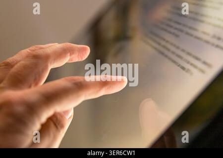 Woman using interactive touchscreen information display in modern museum exhibition hall indoors Stock Photo
